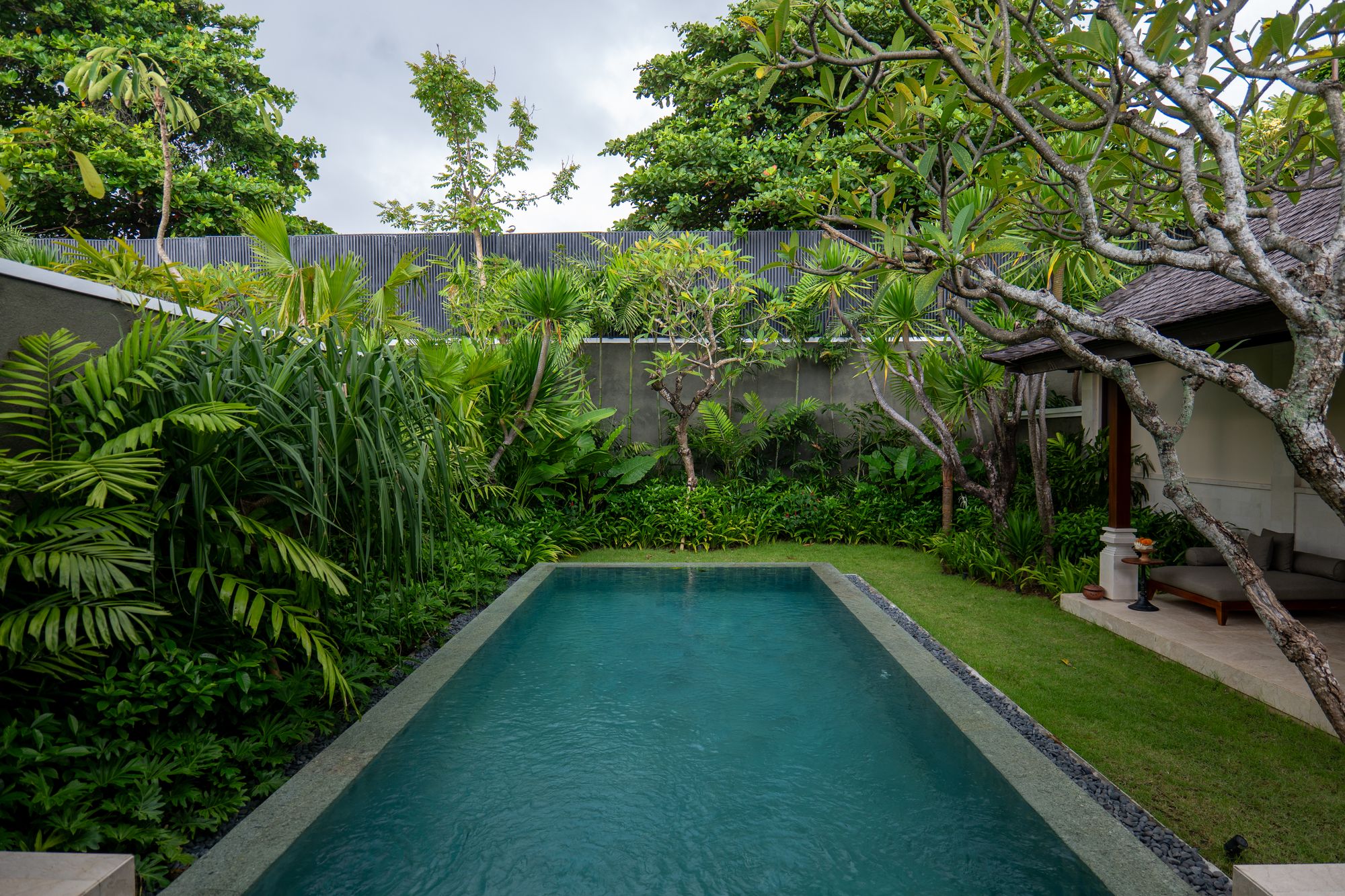 Bali-inspired outdoor courtyard with lush planting and water
